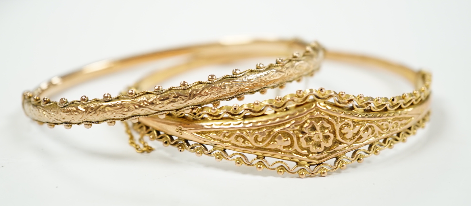 Two yellow metal hinged bracelets, one stamped 9ct gold, hallmarked bracelet 9.2 grams.